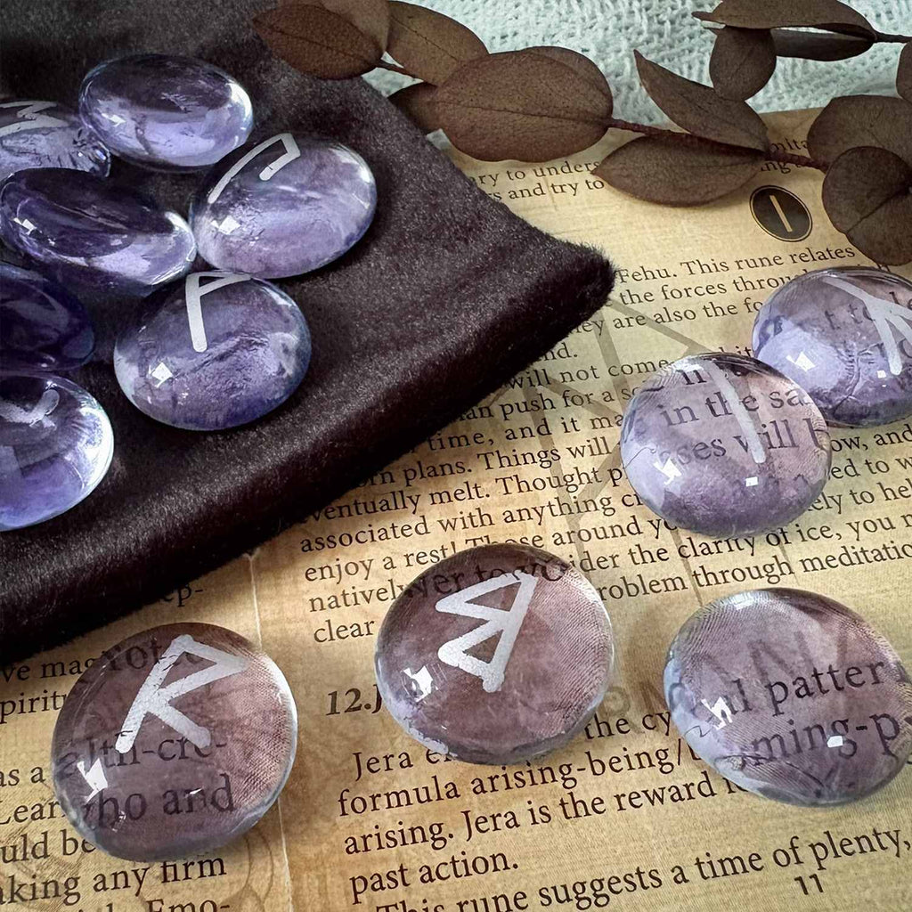 Purple stones with runes on a piece of paper