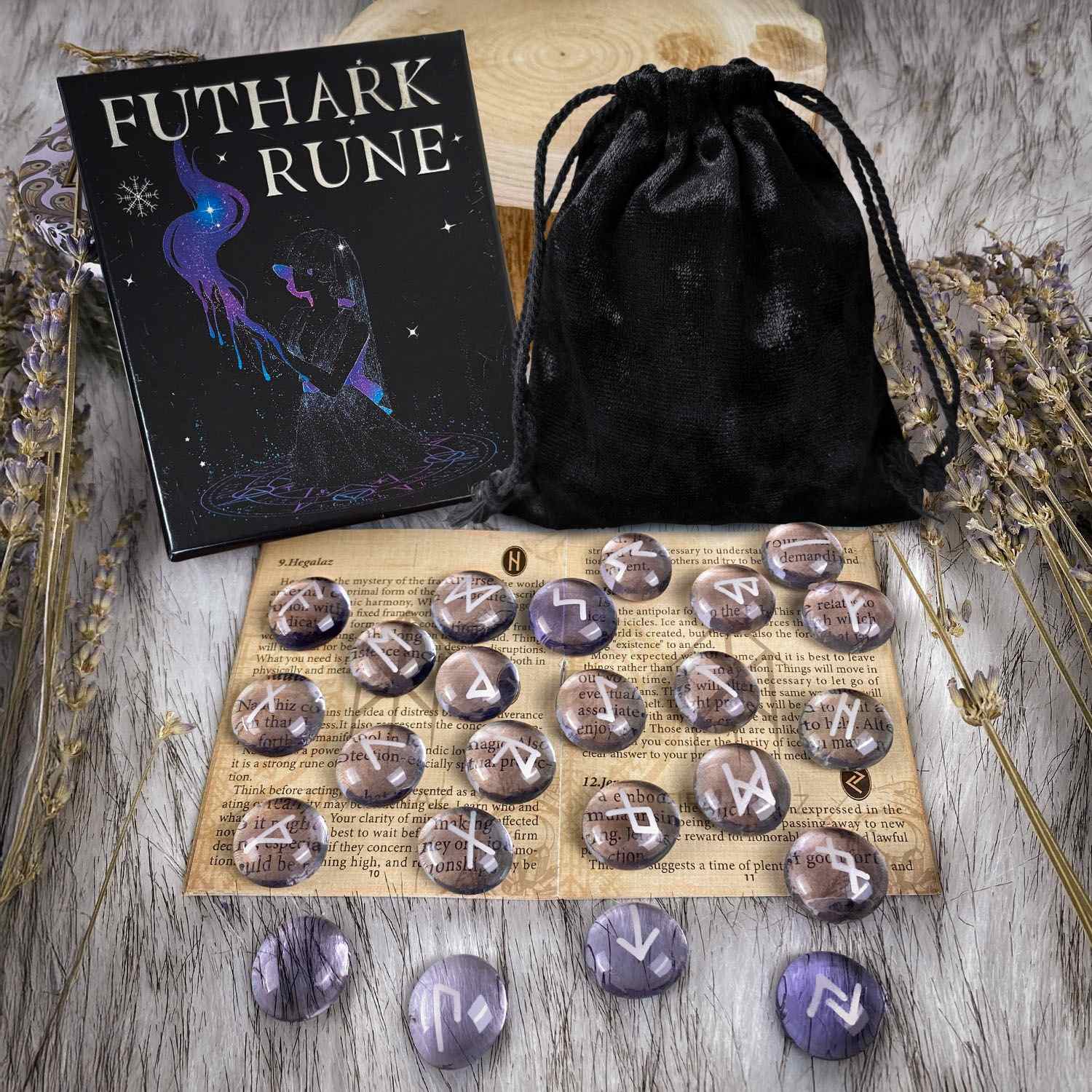 Futhark Rune set with stones, book, and black drawstring bag on a wooden surface.