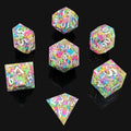 Set of colorful polyhedral resin dice with letter and number embossing on a black background