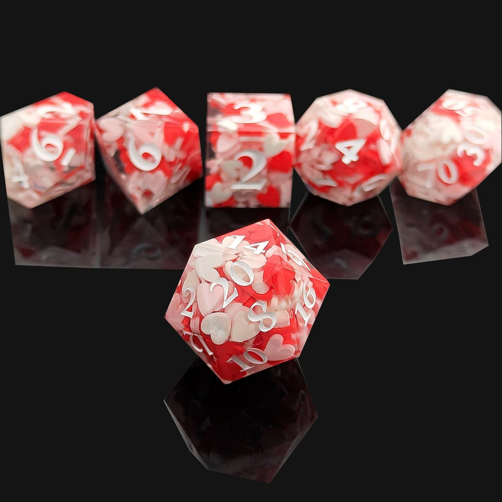 Set of red and white Sharp Edge Polyhedral resin dice on a reflective black surface