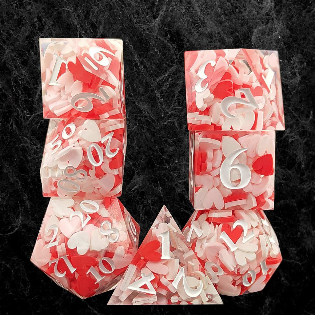 Set of red and white polyhedral dice on a dark textured background