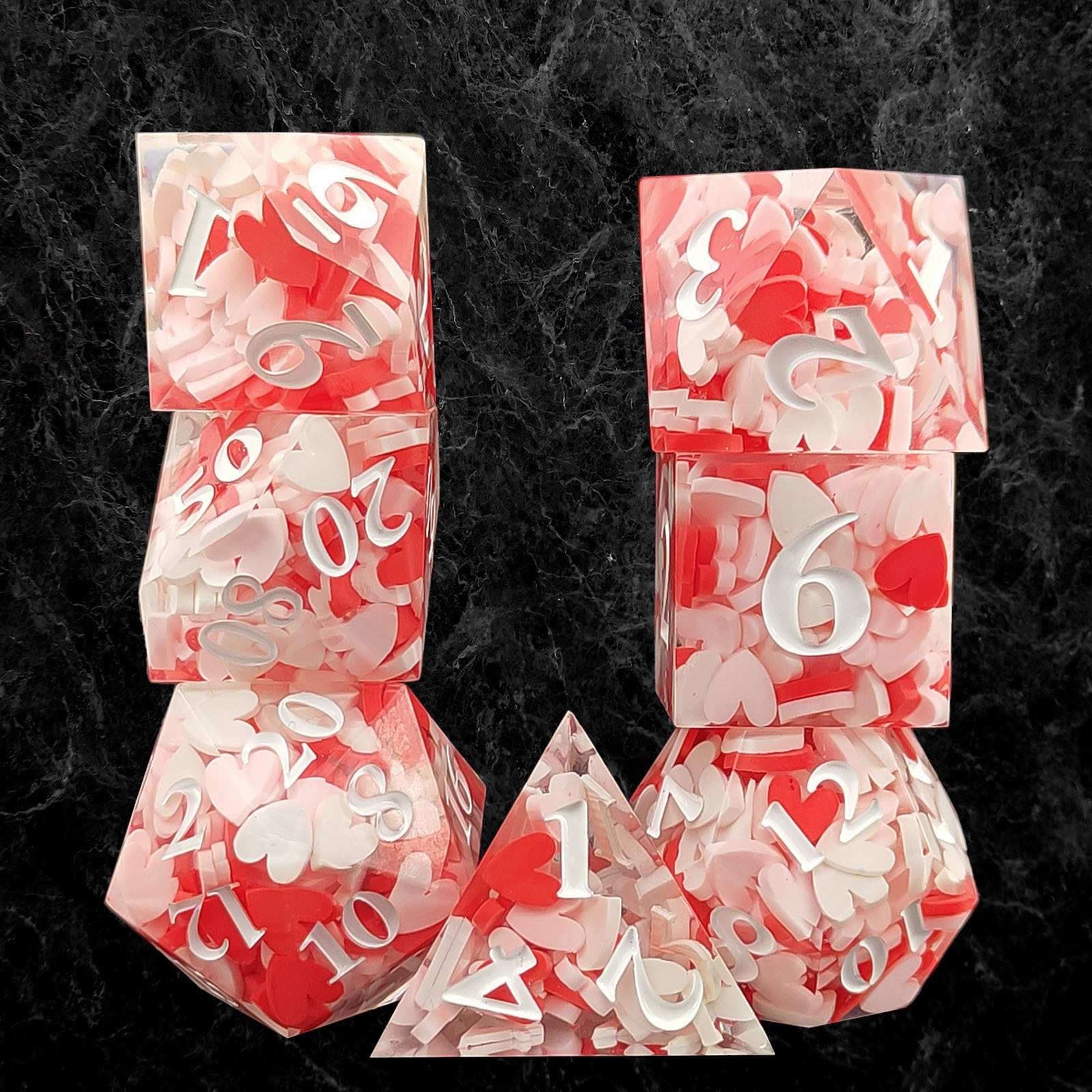 Set of red and white polyhedral dice on a dark textured background