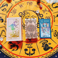 Three Rose Gold Holographic tarot cards on a yellow astrological chart with zodiac signs.