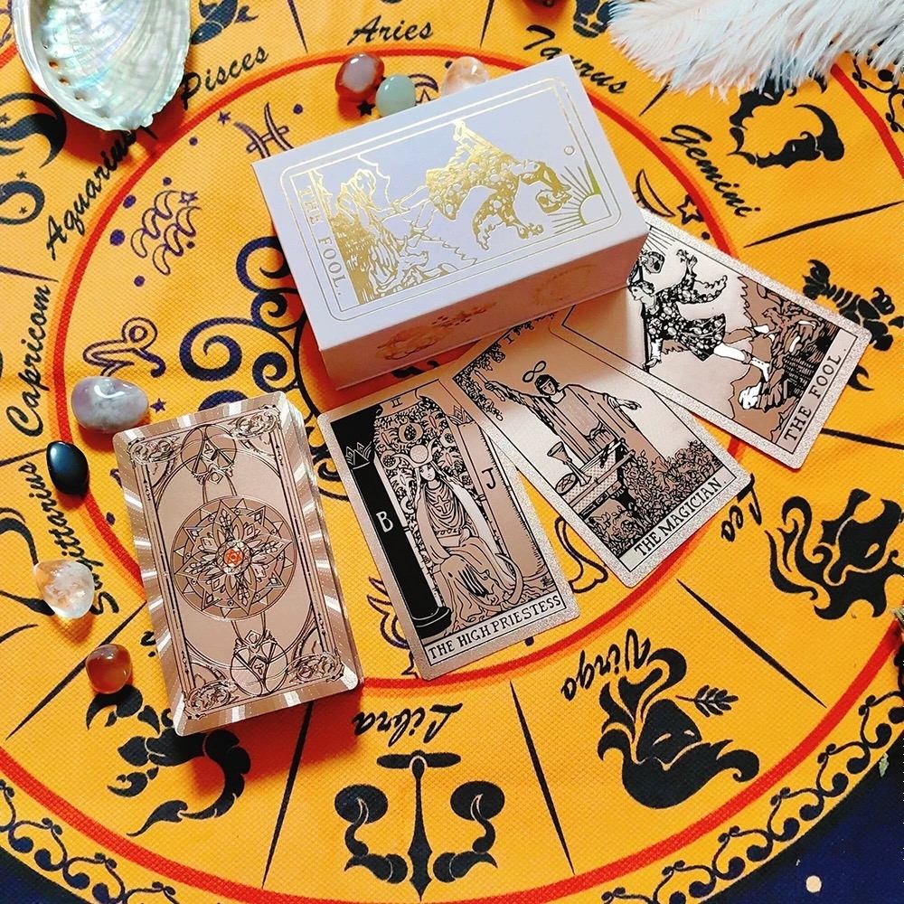 Rose Gold Holographic tarot cards with gold and black designs on a tarot card-style background