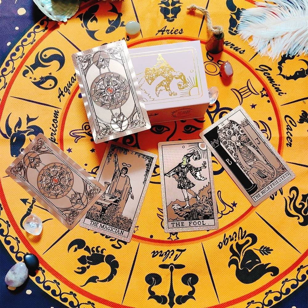 Rose Gold Holographic foil Tarot cards on a yellow tablecloth with zodiac symbols
