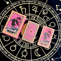 Pink foil tarot cards with 'The Fool' card on a black astrological wheel background