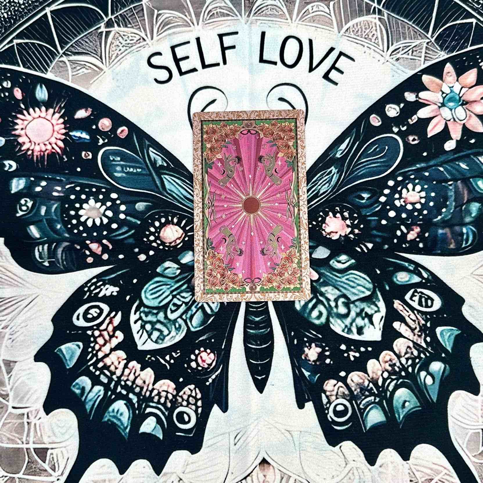 Foil Tarot Card with 'Self Love' text surrounded by decorative butterfly wings and celestial elements.