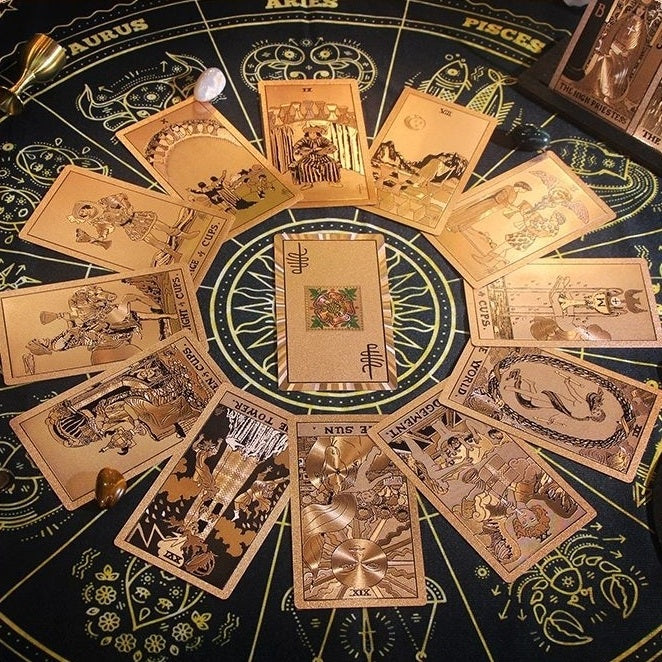 Collection of Rose Gold Foil tarot cards on a zodiac-themed table