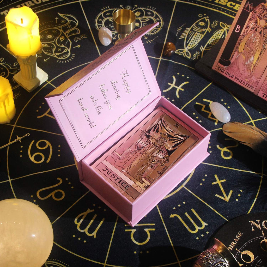 Pink tarot card box with Rose Gold Foil tarot cards on a astrological symbol background