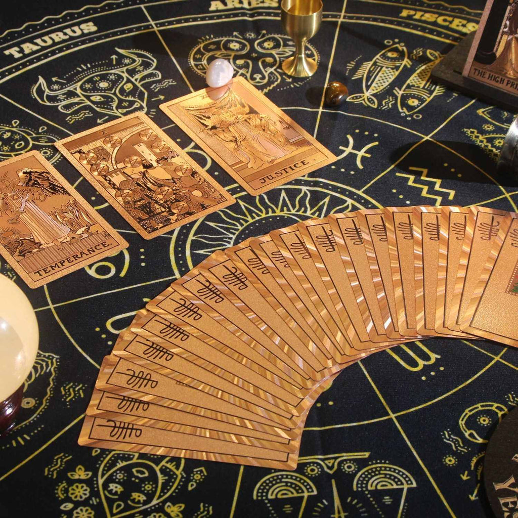 Set of Rose Gold Foil tarot cards on a astrological-themed table
