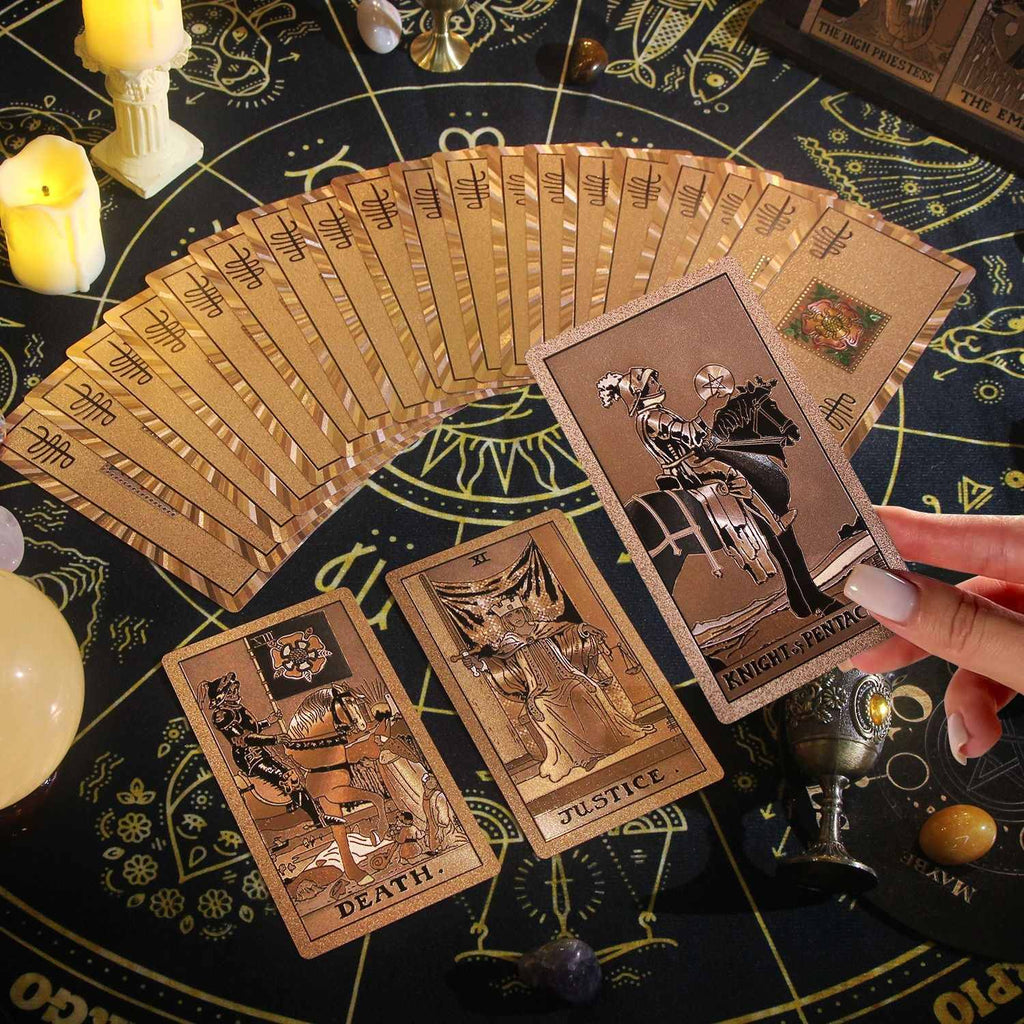 Rose Gold Foil Tarot cards on a mystical table with candles and symbols
