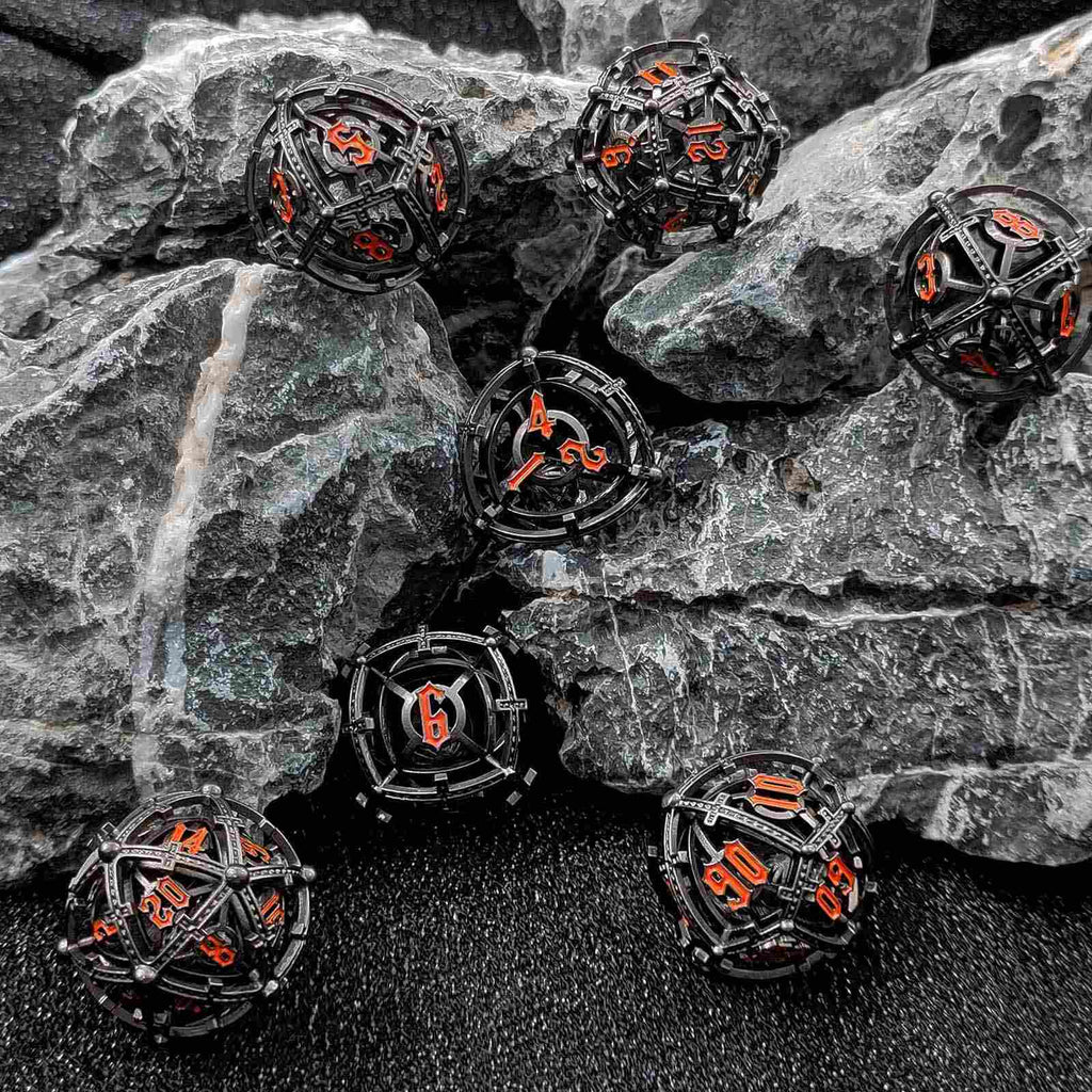 Black and orange Hollow Metal Orb Chime DND dice on a rocky surface