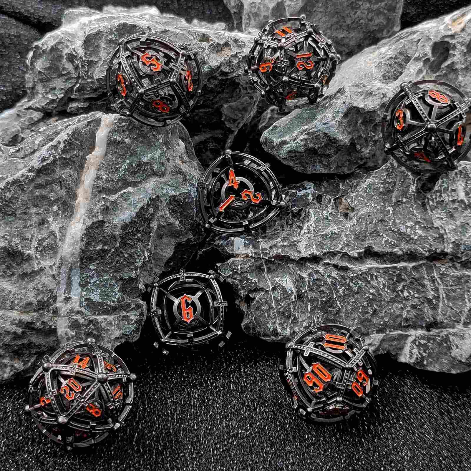Black and orange Hollow Metal Orb Chime DND dice on a rocky surface