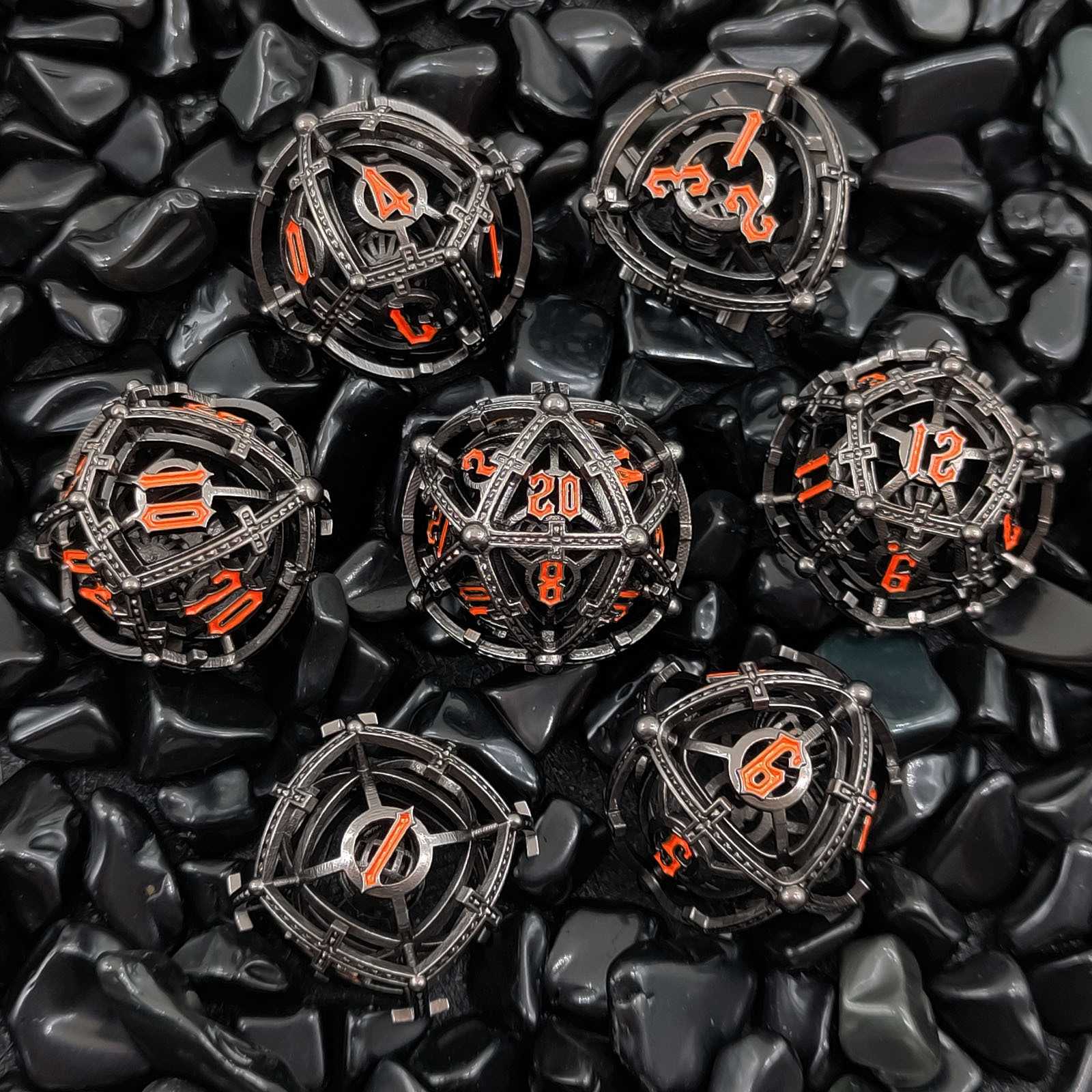 Metallic cage-like Hollow Metal Orb Chime DND dice with orange numbers on a dark stone surface
