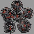 Set of black and orange Hollow Metal Orb Chime DND dice on a white background