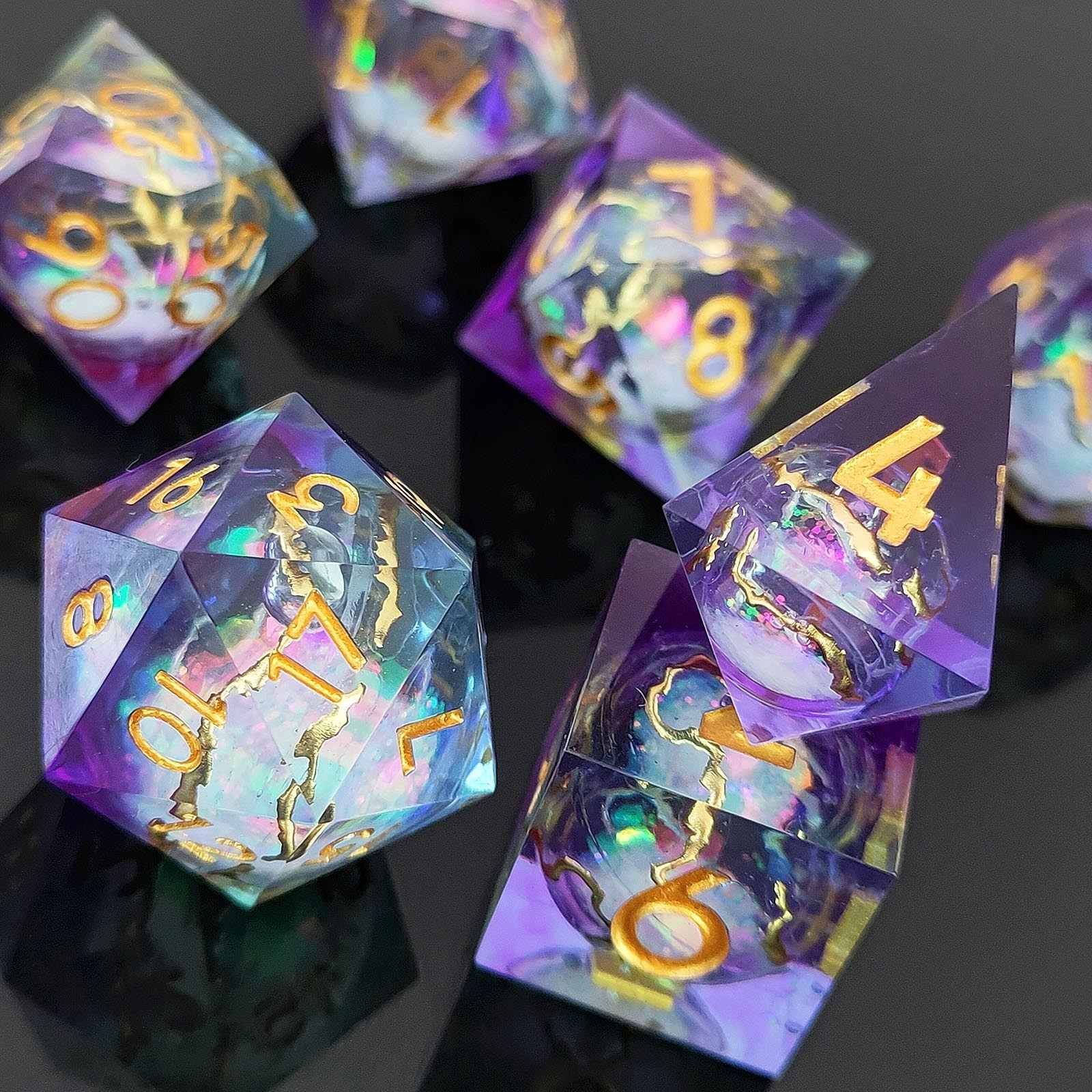 Set of colorful liquid core resin  polyhedral dice with gold numbers on a dark background
