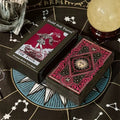 Solis & Luna Gold foil tarot cards with decorative box on a mystical tablecloth.