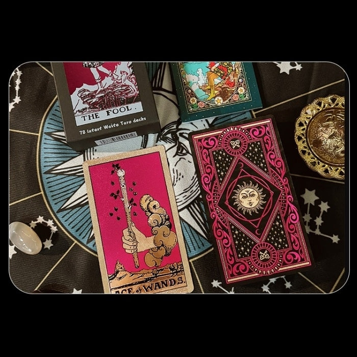 Collection of Gold Foil tarot cards on a black background with star and moon symbols.