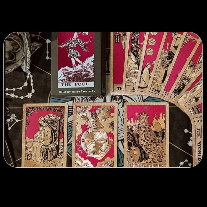 Collection of Gold Foil tarot cards with intricate designs on a dark background