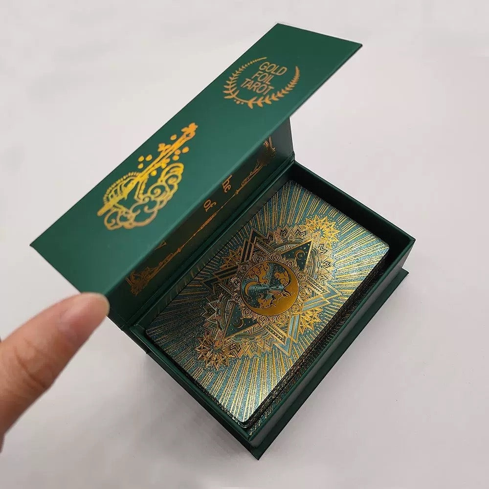 Green and gold tarot card box with intricate designs on a white background