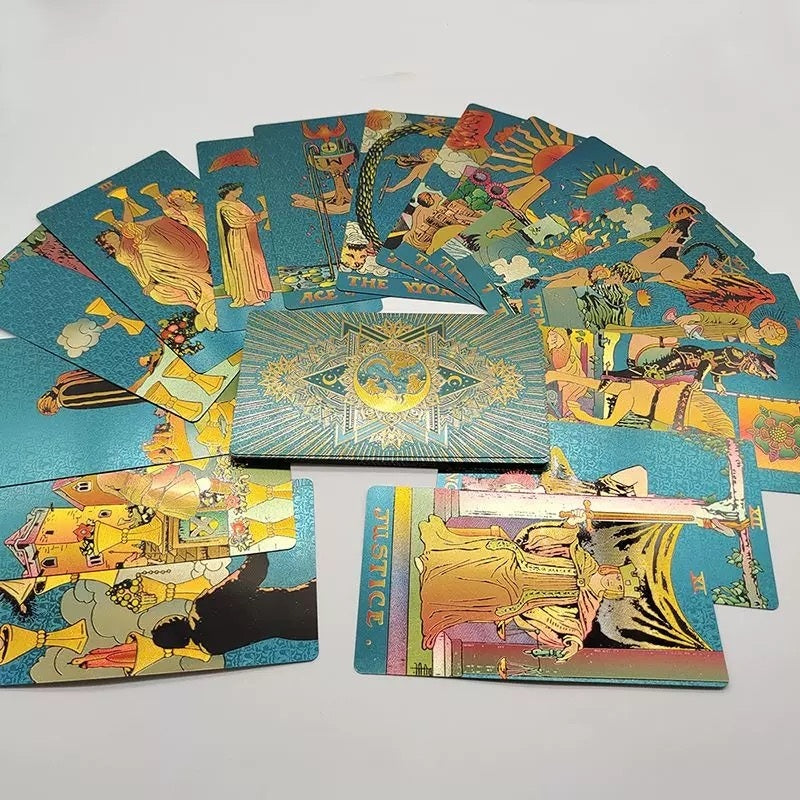 Collection of colorful Teal Foil tarot cards on a light gray background
