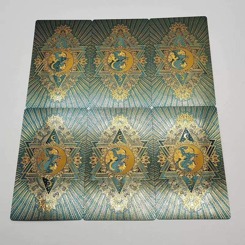 Teal Foil tarot cards with geometric patterns and a dragon design on a gray background