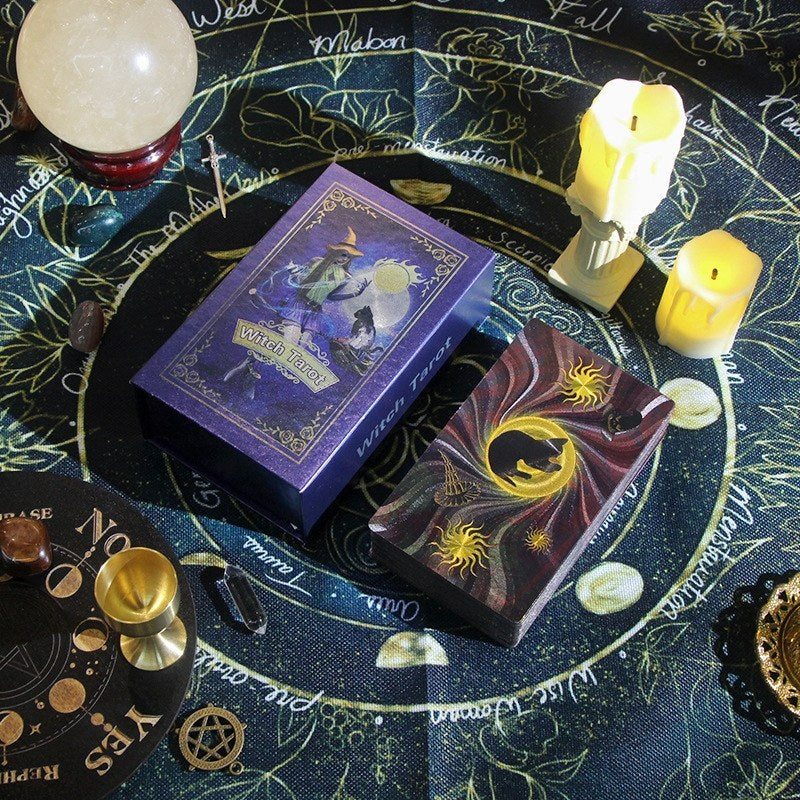 Witch Tarot cards on a tarot table with candles and crystal ball